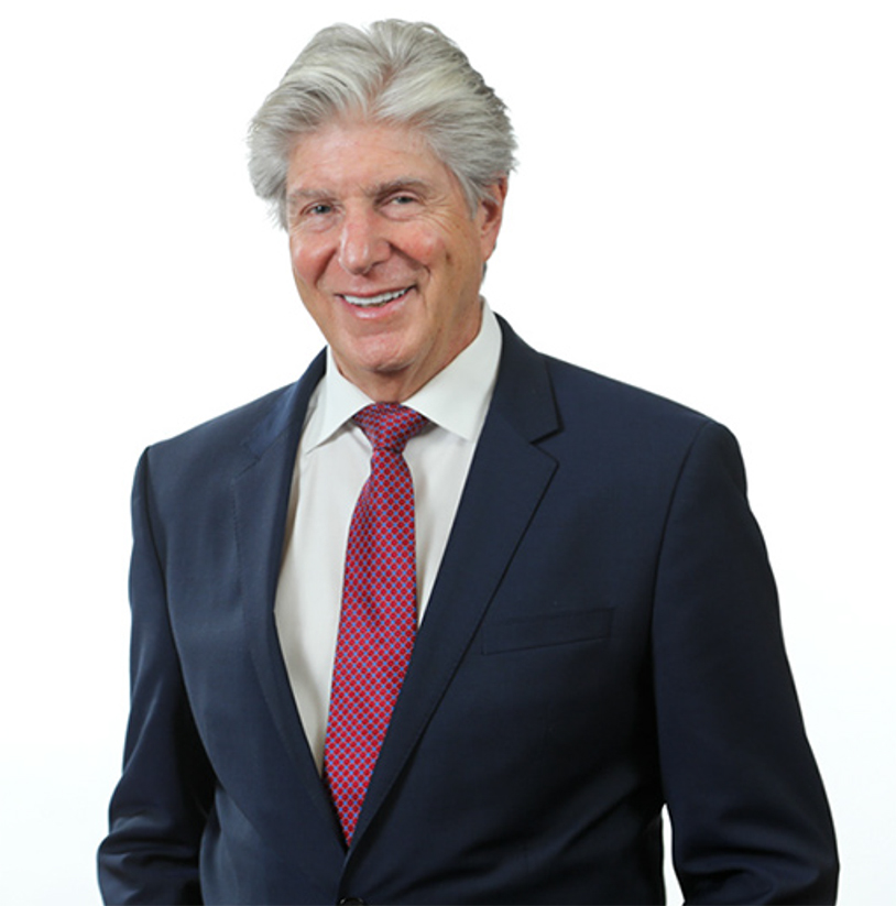 Dr. John Cozzone, Paramus NJ plastic surgeon, dressed in a dark blue suit and red tie